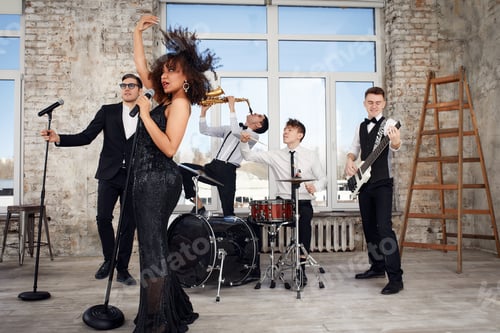 Preview: Repetition of multi ethnic jazz band in loft. Bass guitar player, electric guitar player