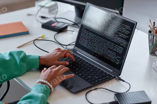 Preview: Woman typing codes on laptop in office