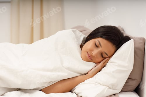 Preview: Serene Woman Sleeping Peacefully in Bed at Home