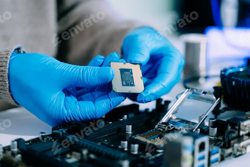 Preview: The technician is putting the CPU on the socket of the computer motherboard. electronic engineering