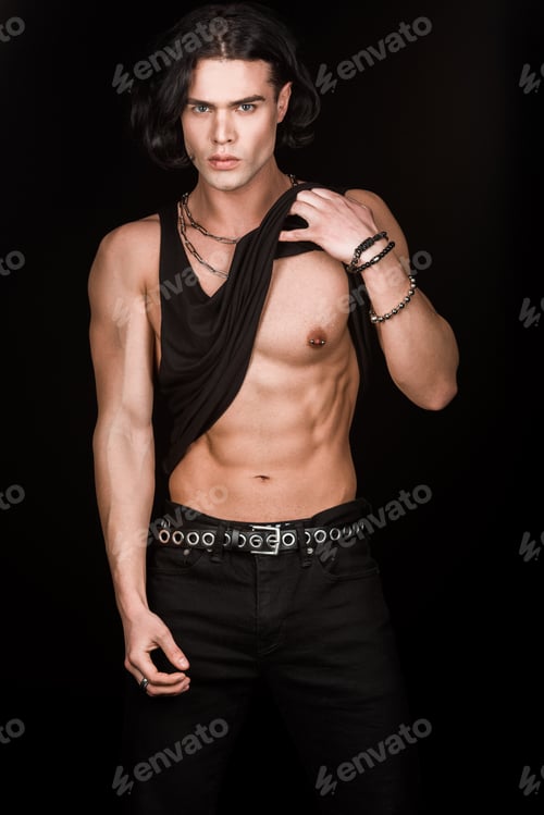 Preview: handsome muscular man touching tank top and standing isolated on black