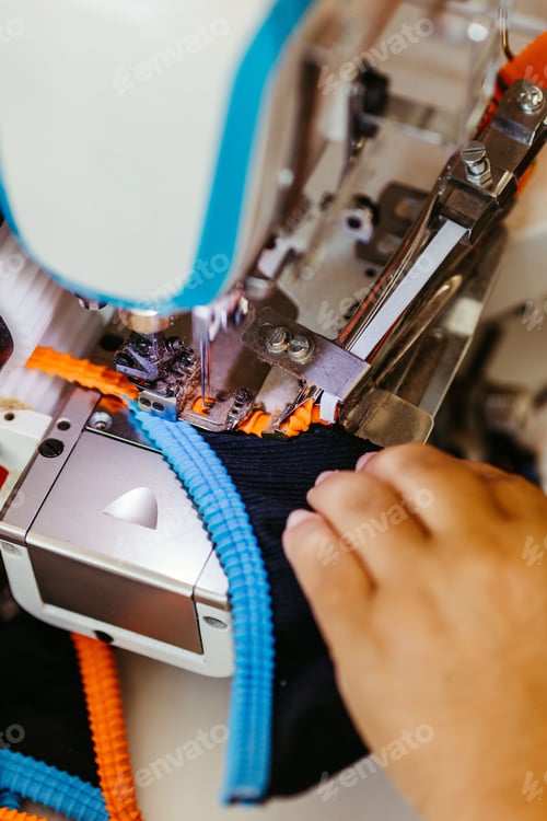 Preview: a close up of a person sewing on a machine with a cord