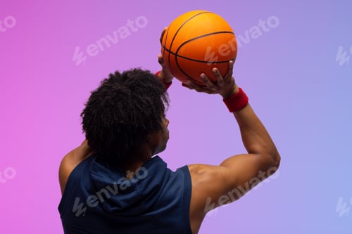 Preview: Image of biracial basketball player throwing basketball on purple to blue background