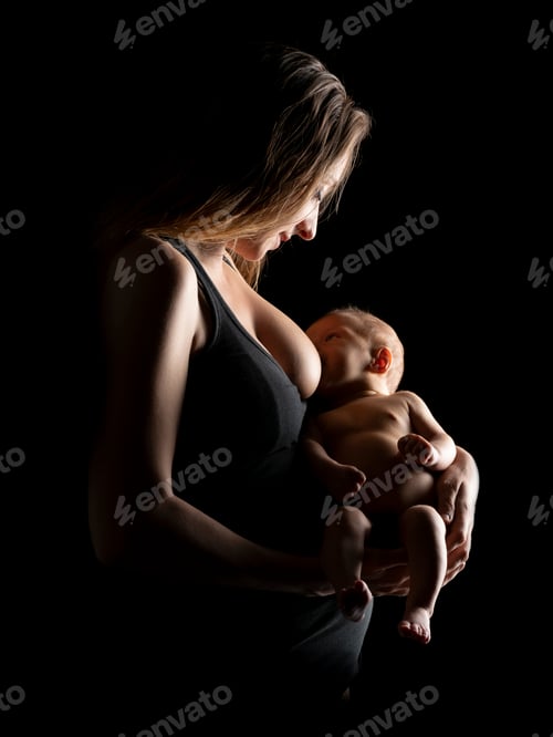 Preview: Young mother in the studio breastfeeding her newborn baby