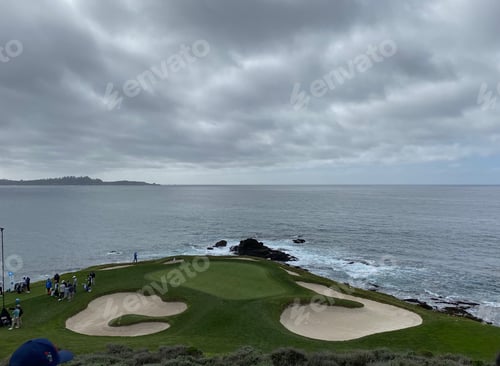Aperçu: The green of a golf hole at Pebble Beach on a cold gray day during the pro am tournament