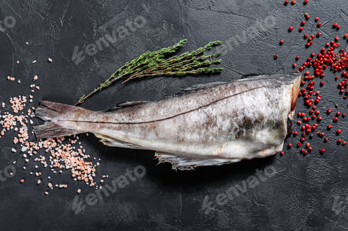 Preview: Raw haddock fish without a head. Black background. Top view