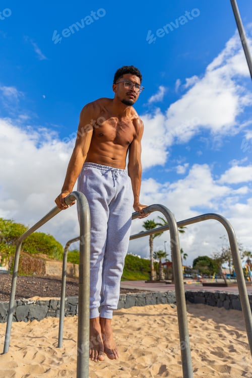 Preview: A man is hanging from bars and training in an outdoor gym