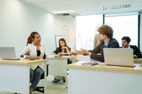 Preview: Successful businesspeople working at office desk.
