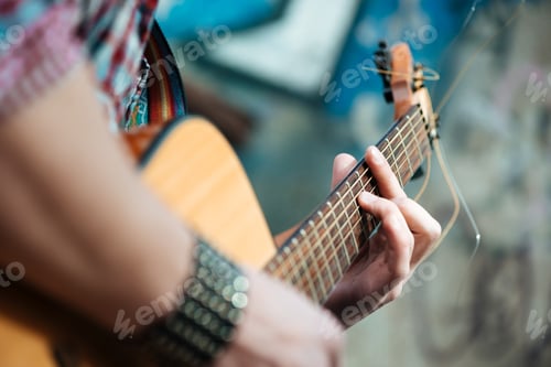 Preview: Male hands playing on guitar outdoors