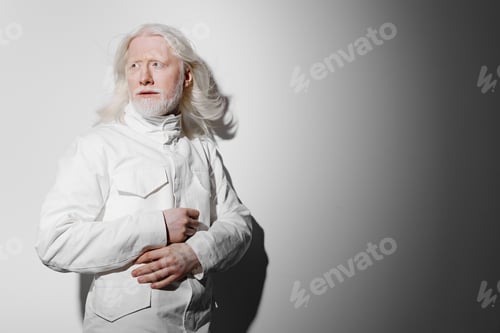 Preview: Elderly man with long white hair in a stylish white outfit standing against a gradient gray