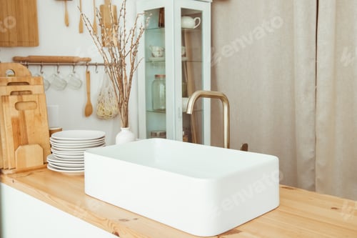 Preview: Kitchen with white sink and faucet wooden countertop. Eco friendly kitchen concept