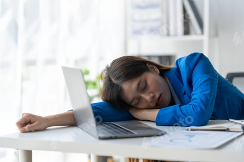 Preview: Young frustrated exhausted woman laid her head down on the table sit work at wood desk with laptop i