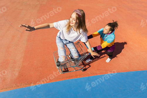 Preview: Multiracial group of young friends bonding outdoors