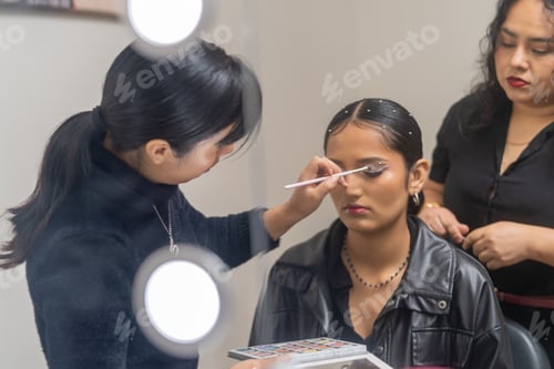 Preview: Make up artist applying eyeshadow to a customer in a beauty salon