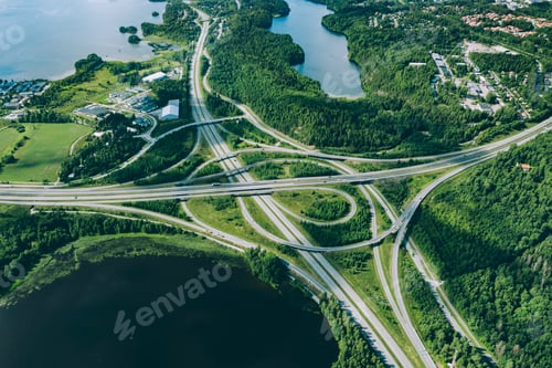 Preview: Aerial view of highway and overpass road with green woods and blue lakes in Finland.