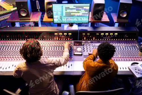Preview: Two People Working at a Sound Mixing Board