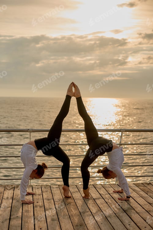 Preview: symmetrical element in gymnastics. Sporty couple doing acroyoga, fitness or pilates practice