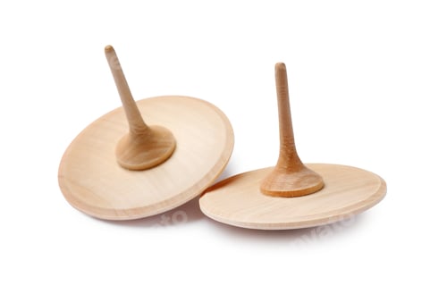 Preview: Two wooden spinning tops isolated on white