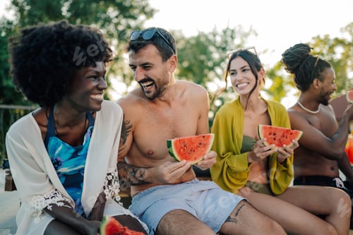 Preview: Happy friends eating watermelon by the pool during summer vacation