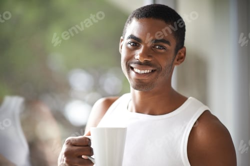 Preview: Relaxing before my busy day. A handsome male holding a hot beverage.