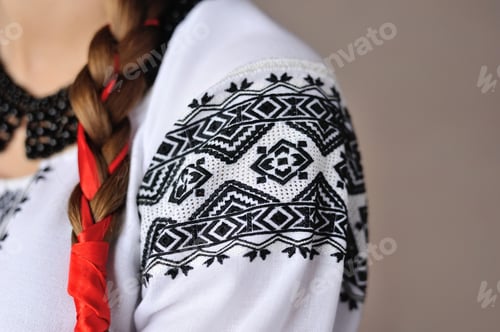 Preview: The girl in an embroidered shirt. Closeup pattern on the sleeve.