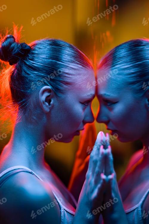 Preview: Reflective Moment Of A Young Woman In Neon Lighting With A Mirror
