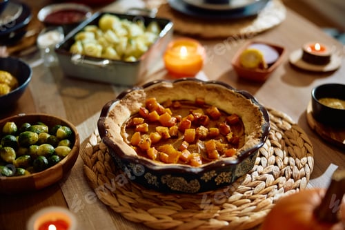 Preview: Traditional Thanksgiving pumpkin pie on dining table.