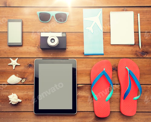 Preview: close up of tablet pc and travel stuff