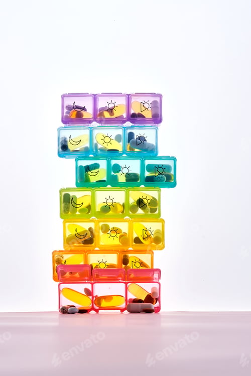 Preview: Bright pill box with different pills and vitamins.