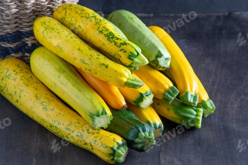 Preview: Yellow-green leopard-spotted zucchini. Vegetables on the table. Zucchini harvest.