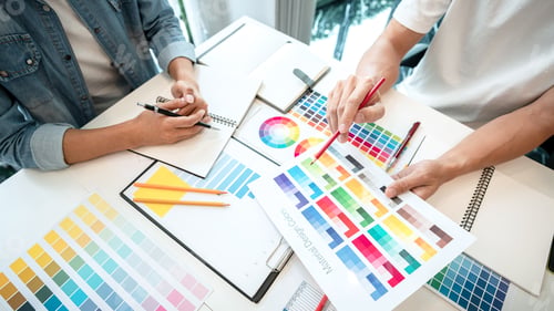 Preview: Two creative graphic designer team working on color selection and drawing on graphic tablet