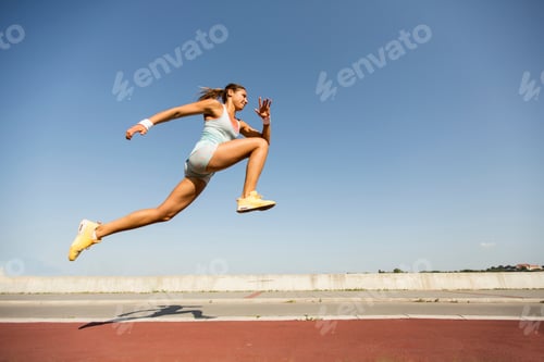 Preview: Young woman taking long jump