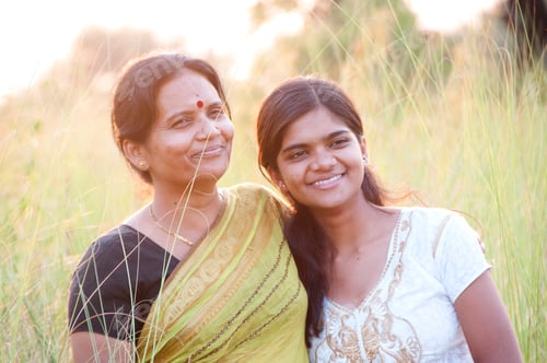 Preview: Portrait of happy mother and daughter in meadow at sunset. Smart Blurred photo