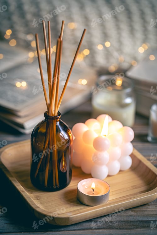 Preview: Winter spa composition with incense sticks, candles and bokeh lights.