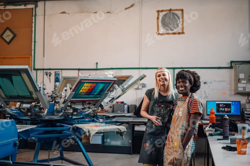 Preview: Female graphic industry workers standing at facility and smiling.
