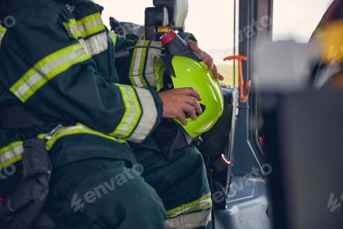 Preview: Portrait of firefighter wearing protective uniform in the fire machine