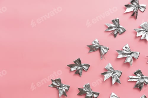 Preview: silver ribbon bows on pink background. festive template