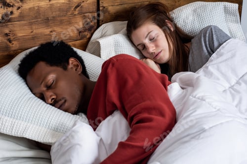 Preview: Young couple sleeping in a bed.
