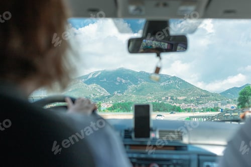 Preview: Female sitting on the front seats of a car moving along the highway