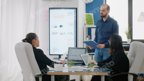 Preview: Team of colleagues discussing business strategy at meeting