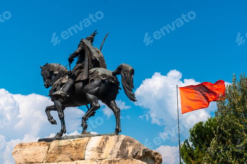 Preview: Skanderbeg horse monument at Skanderbeg Square in Tirana and the red flag of Albania