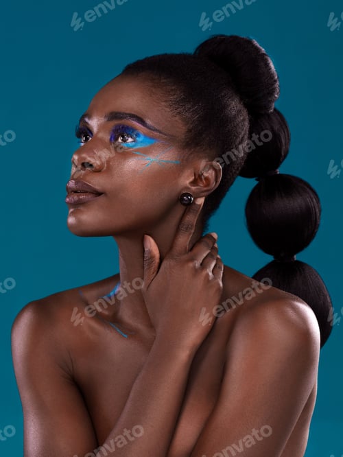 Preview: Studio shot of a beautiful young woman posing against a turquoise background