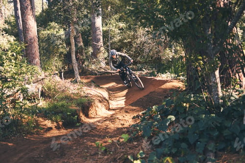Preview: Trail, mountain bike and man cycling in the forest or woods fast, speed and adrenaline in training.