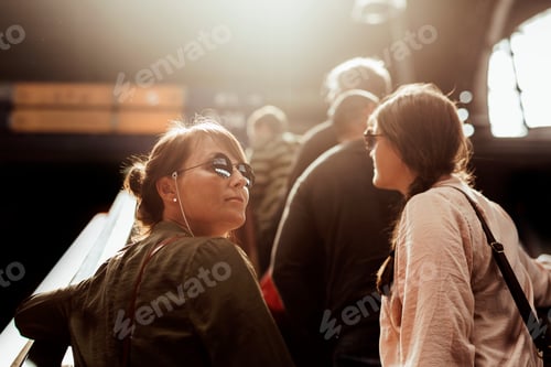 Preview: Two women going up escalator