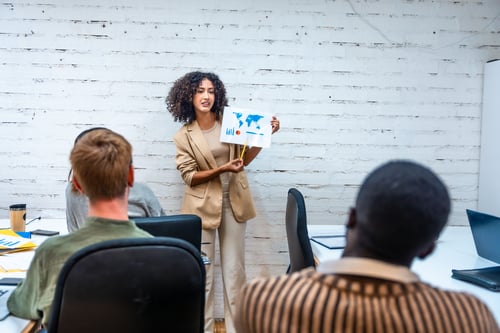 Woman showing an infographic during a coworking meeting