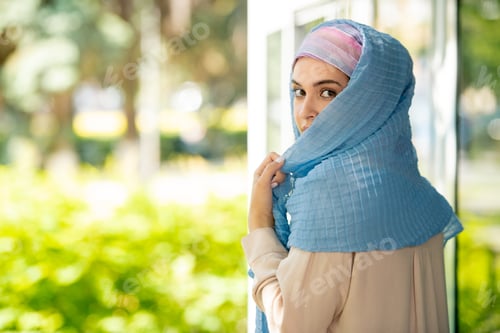 Preview: Elegant Woman in Headscarf Outdoors by Window