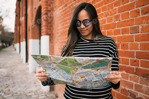 Preview: Young traveler woman with a map.