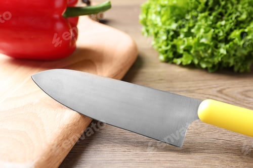 Preview: Cutting board and sharp chef's knife on wooden table