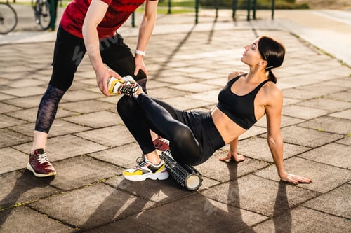 Preview: Cropped photo of young sporty couple training together on sportsground