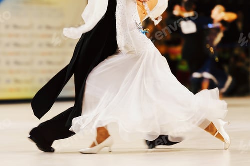 Preview: partner dancing tango in ballroom dancesport, woman is wearing white dress